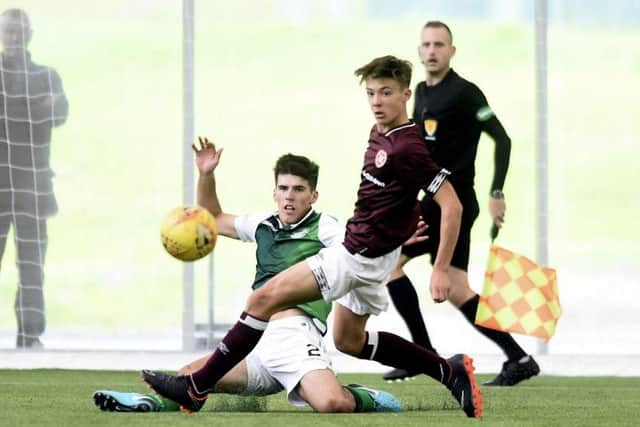 Kane O'Connor challenges Aaron Hickey during an SPFL Reserve Cup tie between Hearts and Hibs. Picture: Lisa Ferguson