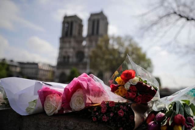 Flowers laid on a bridge in front of Notre-Dame following this weeks devastating fire. Picture: AFP/Getty Images