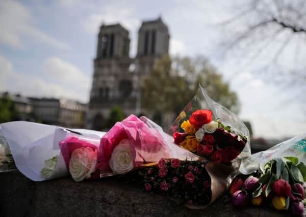 Flowers laid on a bridge in front of Notre-Dame following this weeks devastating fire. Picture: AFP/Getty Images