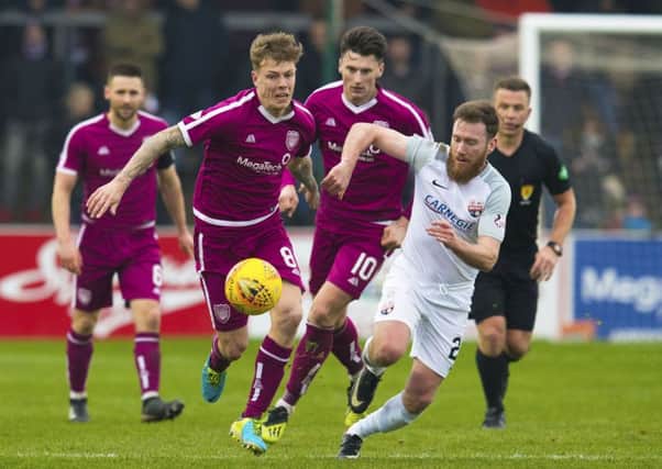 David Gold, pictured taking on Montrose's Patrick Cregg, is on the cusp of the League One title with Arbroath. Pic: SNS