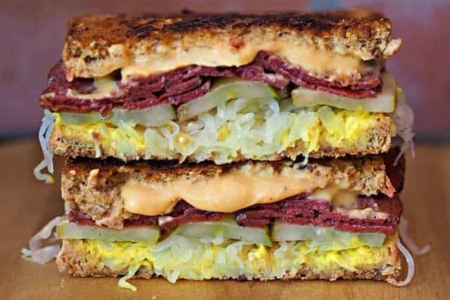 The Reuben from FacePlant Food with sauerkraut, pickles, mustard, cheeze and deli slices of FacePlant pastrami.