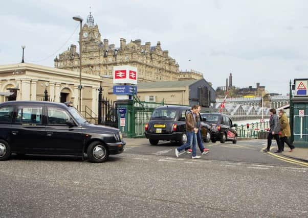 Taxis queue to go through a set of two barriers. Pic: Malcolm McCurrach