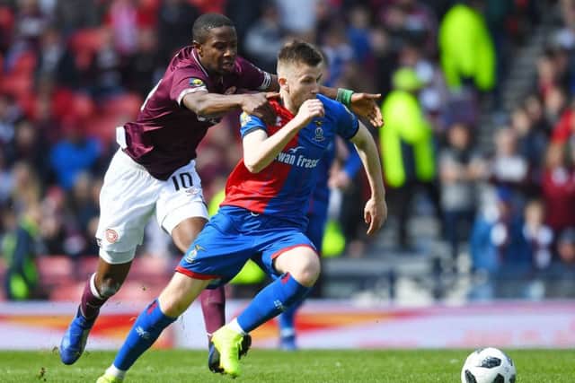 Hearts star Arnaud Djoum, left, battles with with Liam Polworth during the William Hill Scottish Cup semi-final