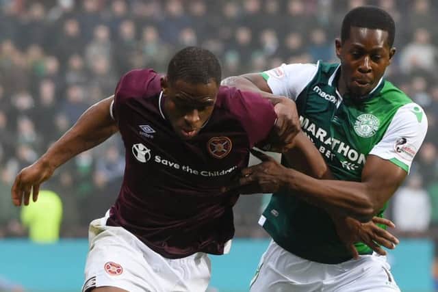 Marvin Bartley (right) battles for the ball with Hearts striker Uche Ikpeazu in the Edinburgh derby. Picture: SNS Group