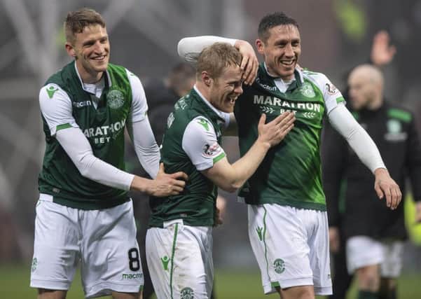 Vykintas Slivka, left, and Mark Milligan, right, celebrate at full time after defeating Hearts in the derby with two-goal Daryl Horgan