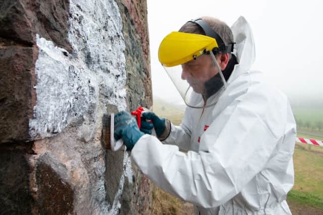 Cleaning graffiti off St Anthony's Chapel in Holyrood Park
