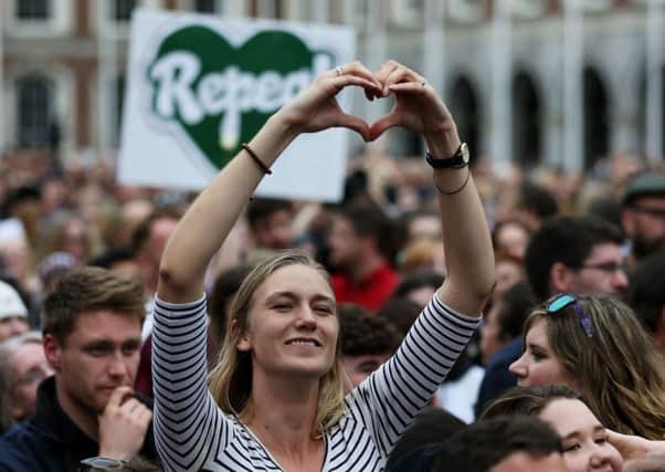 People celebrate at Dublin Castle as the official result of the abortion referendum is announced, in favour of repeal. Picture: PA