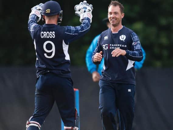 Con de Lange (right) celebrates with Matthew Cross after taking a wicket during his 5-60 haul against Zimbabwe in June 2017