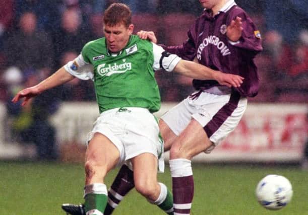 David Weir challenges Hibs striker Keith Wright during the 1996-97 season