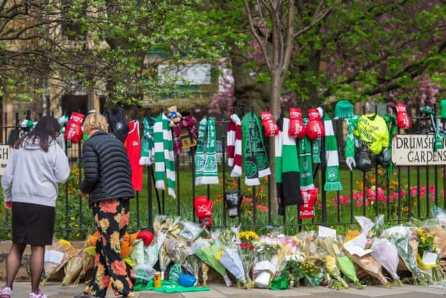 Pictured on Tuesday, six days on from the murder, lots of scarves - of Hibs and Hearts colours - are draped from the fence close to the scene. Pic: Ian Georgeson
