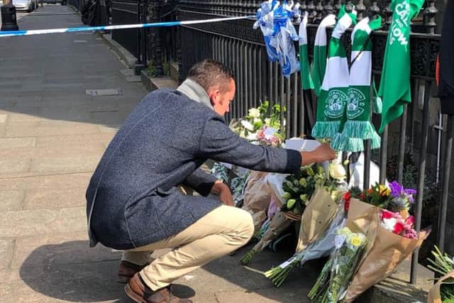 Tributes are left at the scene on the day after the murder.