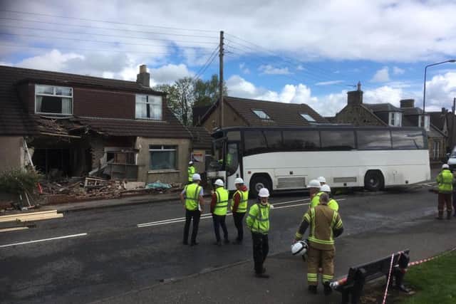 The driver of the single decker is said to have escaped with minor injuries in the accident in Main Street, East Whitburn. Picture: Ian Rutherford