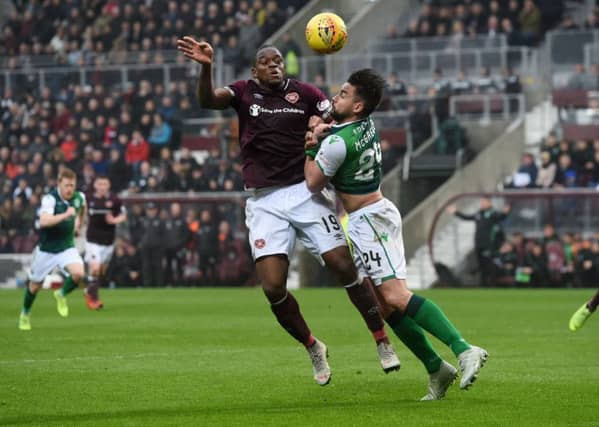 Hibs defender Darren McGregor gets to grips with Hearts striker Uche Ikpeazu. Picture: SNS group