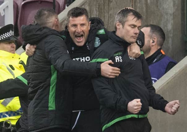 Hibs manager Paul Heckingbottom, first-team coach Grant Murray and assistant manager Robbie Stockdale celebrate Daryl Horgan's goal to make it 2-1 in the derby at Tynecastle