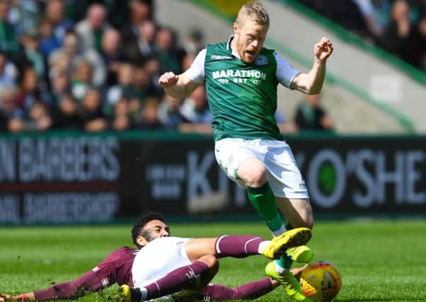 Hibs winger Daryl Horgan is challenged by Sean Clare