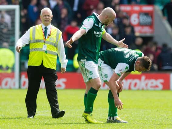 Hibs players David Gray and Mark Milligan rue a victory that got away.
