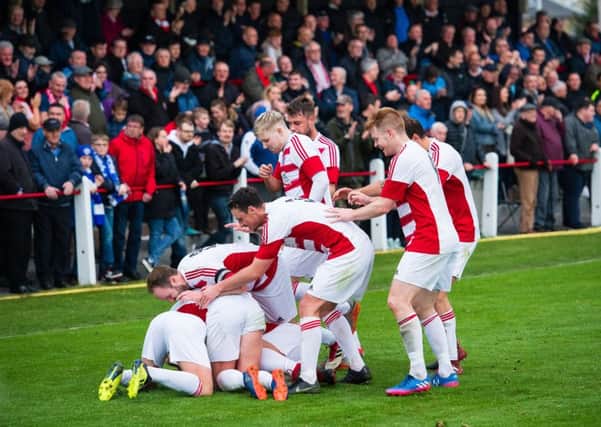 The Bonnyrigg Rose players celebrate after Dean Brett put them two goals up against Penicuik. Pictures: Ian Georgeson