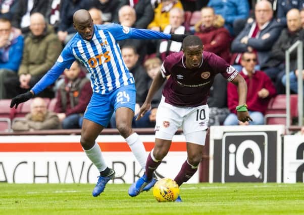Hearts' Arnaud Djoum (right) and Kilmarnock's Youssouf Mulumbu in action. Pic: SNS