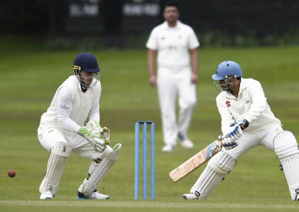 Stewart's Melville wicketkeeper Ben Wilkinson and Carlton's Arun Pillai, who  hit 50. Picture:  Neil Hanna Photography