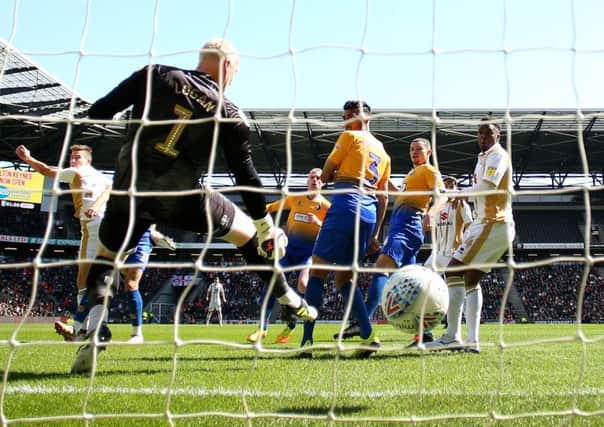 Conrad Logan is left helpless as MK Dons score to consign Mansfield to the play-offs. Pic: SNS