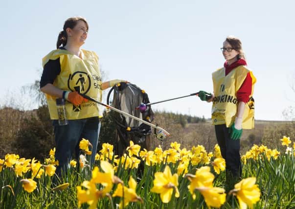 Melanie Aiken, right, and Lucy Manning help clean up Burdiehouse Park (Picture: Toby Williams)
