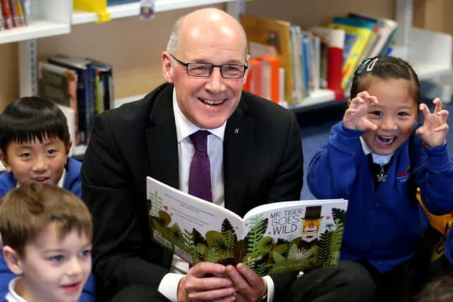 Education Secretary John Swinney reads to pupils in Edinburgh. Picture: Jane Barlow/PA