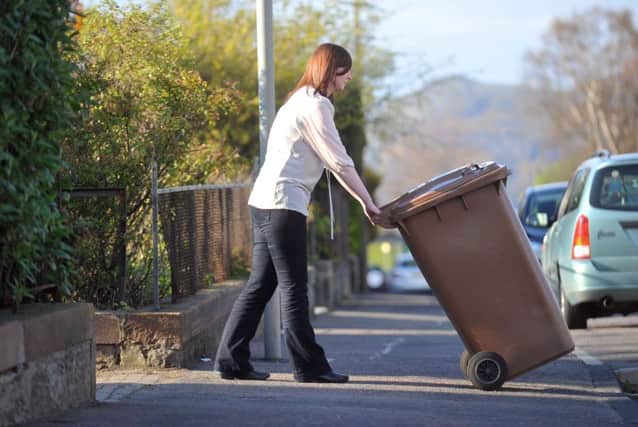 Pictured is a garden waste bin being placed out for collection. Pic: Jane Barlow