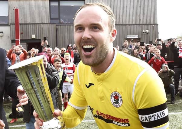 Johnny Stewart celebrates after winning the East of Scotland League title
