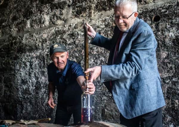 Hector McMurchy, assistant distillery manger at Glen Scotia, with Michael Russell MSP. PIC: Contributed.
