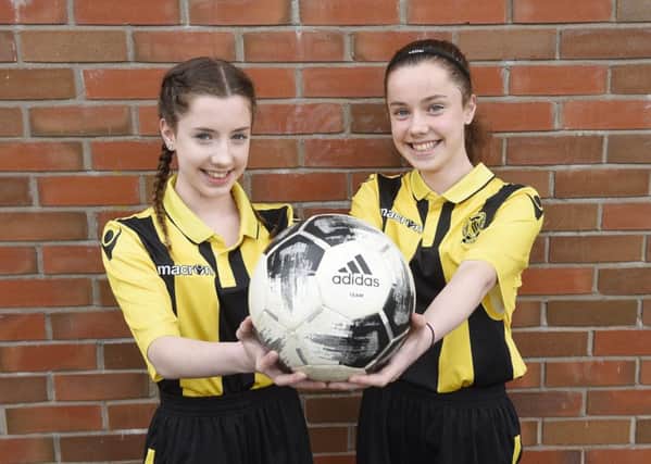 Lauren and Sophie MacDonald both dream of playing for Arsenal when they are older.  Picture: Greg Macvean