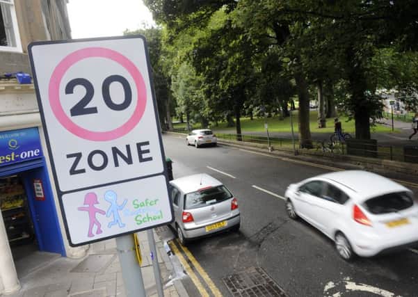 Cars and 20mph speed signs in Edinburgh. Pic: Greg Macvean