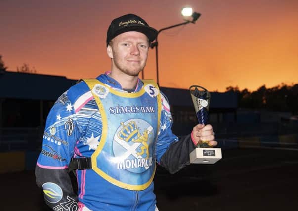Edinburgh Monarchs top rider of the night Cameron Heeps in the sunset with his trophy. Picture: Ron MacNeill