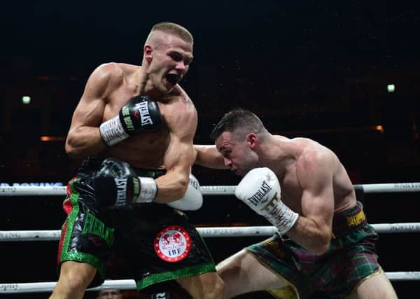Josh Taylor lands a body blow to Ivan Baranchyk during their fight. Pic: SNS