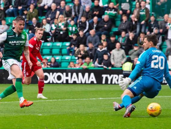 Hibs striker Marc McNulty slots the ball under Tomas Cerny to open the scoring against Aberdeen