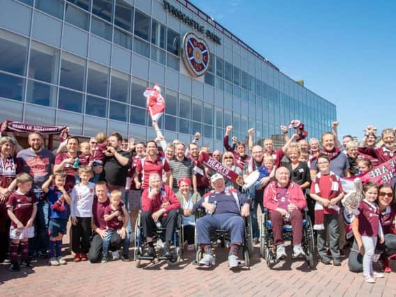 Jambos fans cheer on their team at Tynecastle today