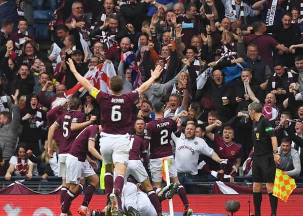 Hearts' players celebrate Ryan Edwards' opener with the fans
