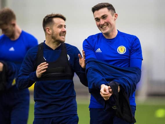 Marc McNulty, left, and John Souttar share a joke during a Scotland training session