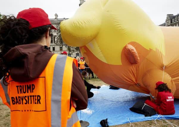 Trump Babysitters inflate the Trump Baby Blimp in Parliament Square. Picture: Getty