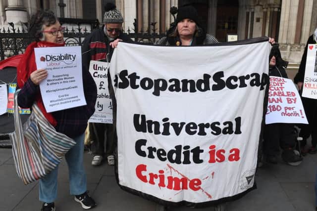 Campaigners outside the Royal Courts of Justice supporting a legal challenge against the UK Government's Universal Credit welfare scheme