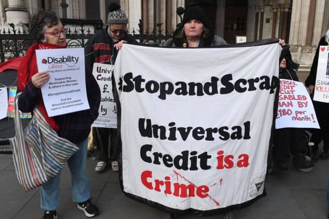 Campaigners outside the Royal Courts of Justice supporting a legal challenge against the UK Government's Universal Credit welfare scheme