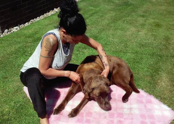 Pictures of Athena Christodoulou massaging her dog clients