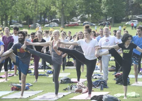 People take part in yoga during the Meadows Festival. Pic: Greg Macvean