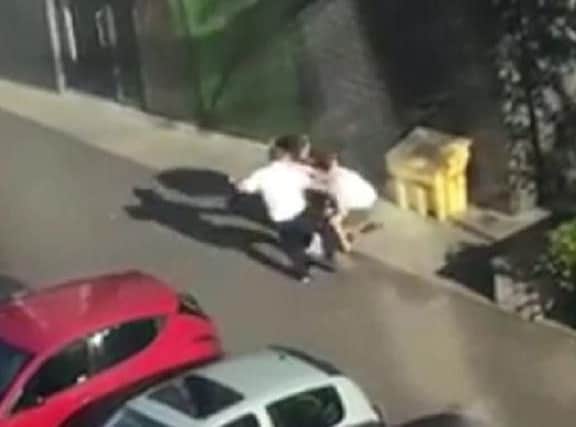Two of the men captured in the video then begin fighting with the remaining male, before knocking him to the ground.