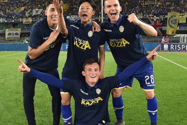 Liam Henderson (centre, bottom) celebrates with his Verona team-mates after winning promotion to Italy's Serie A