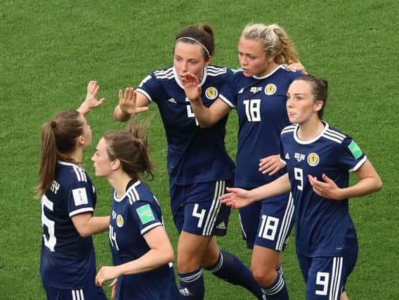 Claire Emslie (No.18) is congratulated by her team-mates after scoring Scotland's goal