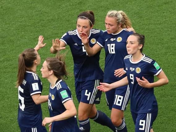 Claire Emslie is congratulated by her team mates after scoring Scotland's goal on Sunday.
