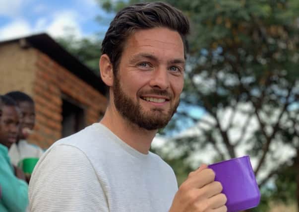 Celtic goalkeeper Craig Gordon has enjoyed a mug of porridge and a game of football during a visit to a
Malawi primary school