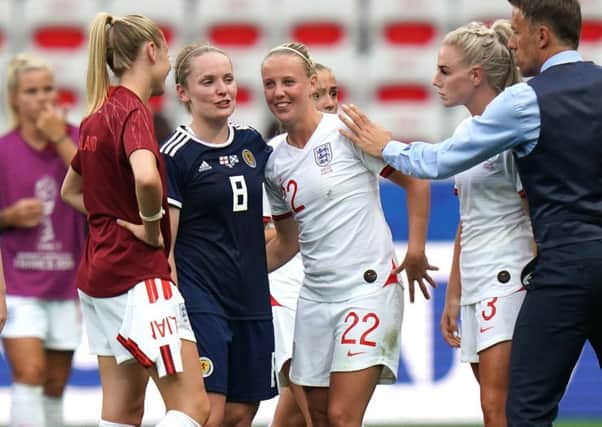 Kim Little smiles with Englands Beth Mead after the final whistle of their World Cup opener