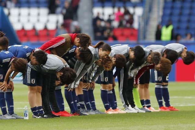 The Japan players bow to their fans after their disappointing 0-0 draw with Argentina