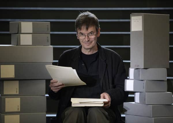 Scottish crime writer Ian Rankin, holding his 1984 manuscript for his first published novel Flood, with some of the 50 boxes of his own personal archive which he is donating to the National Library of Scotland, Edinburgh.